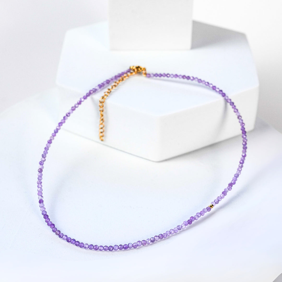 NAM025 Girocollo in acciaio chirurgico dorato e ametista