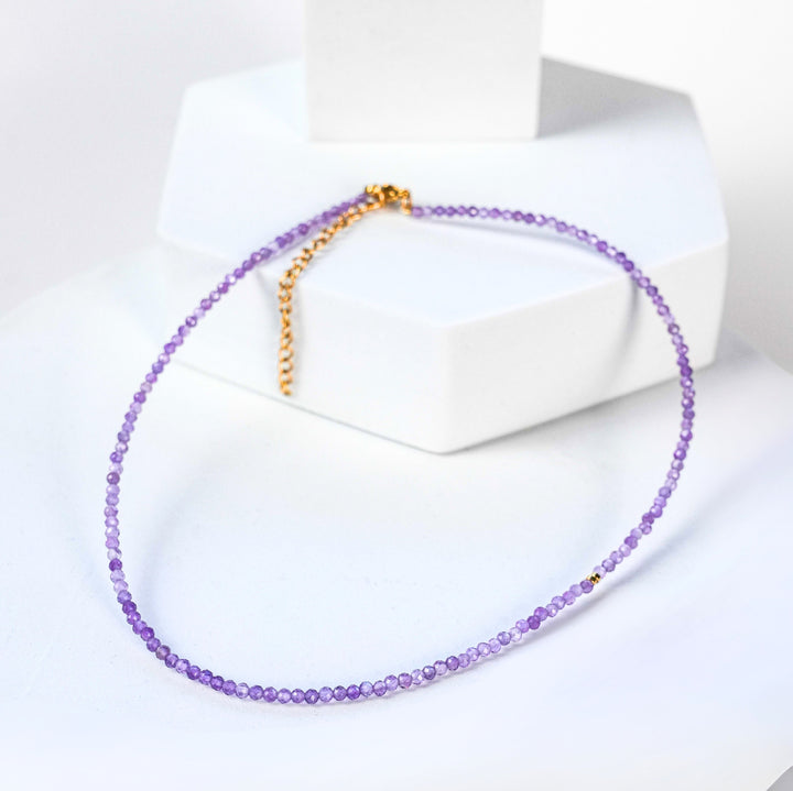 NAM025 Girocollo in acciaio chirurgico dorato e ametista